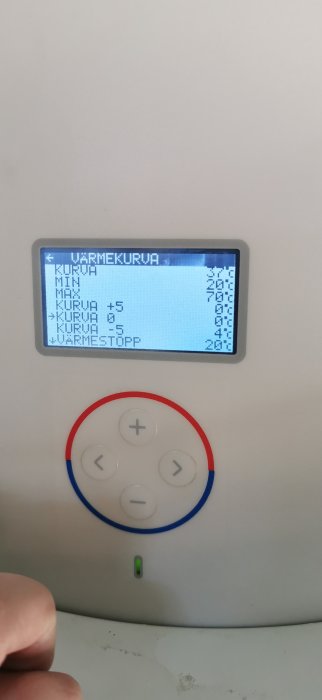 Digital display of a heating system showing high temperature warning with control buttons.