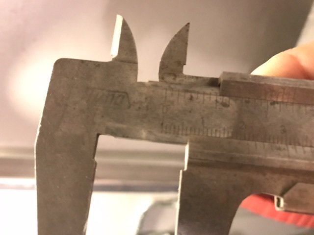 Skjutmått som mäter diametern på en objekt, visar cirka 2,1 cm på skalan.