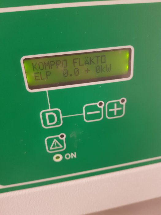 Digital display på en enhet som visar "KOMPR FLÄKT: 0.0 ELP: 0.0 + 0kW" och kontrollknappar.