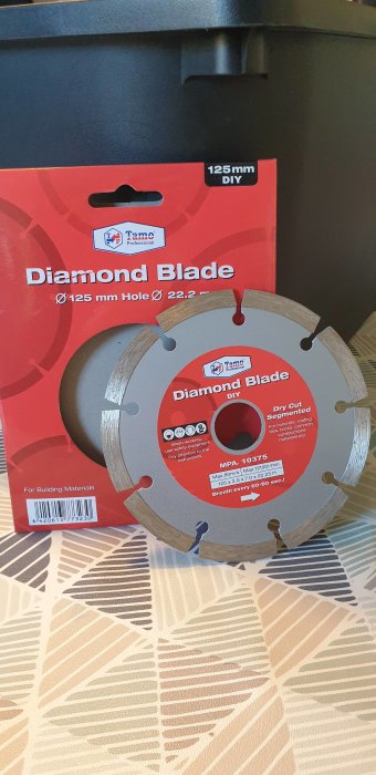 Diamantkapskiva för byggmaterial på ett mönstrat underlag, föreslagen för kapning av kakel ovanför en toalettdörr.