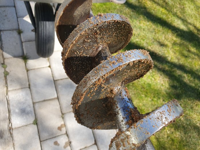 Jordborr med diameter 145 mm täckt med sand och jord, använd för att borra ner till grundvatten på 3,5 meters djup.