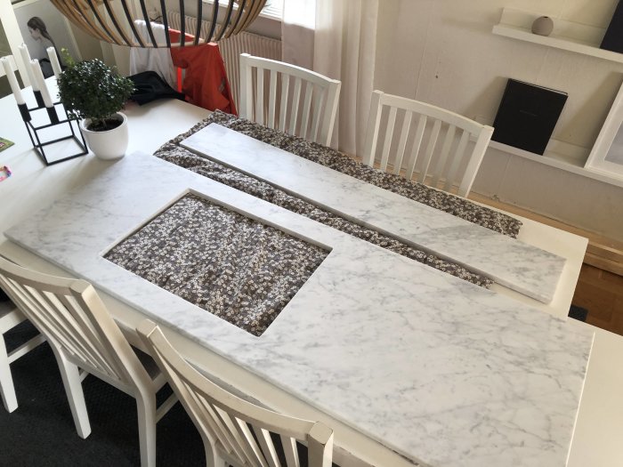 Marble countertops with cutouts for sinks on a dining table, ready for bathroom vanity installation.