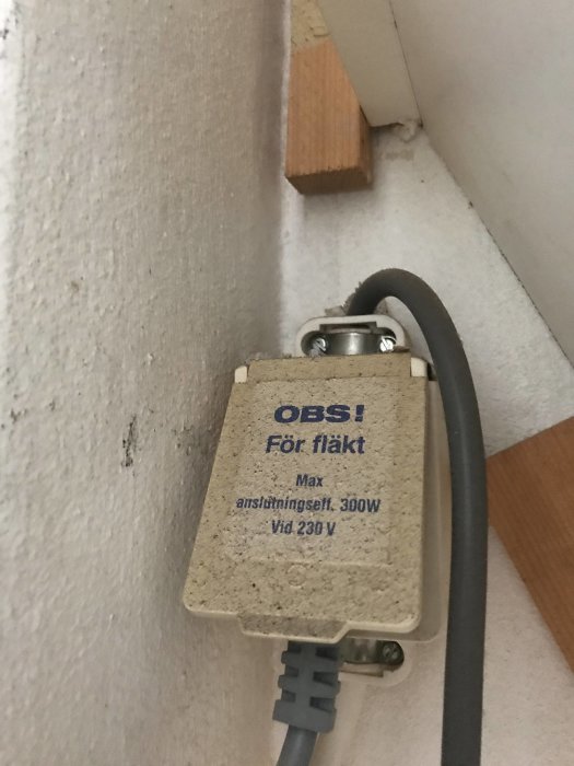 Eluttag för köksfläkt märkt med "OBS! För fläkt" och tekniska specifikationer på en vägg.