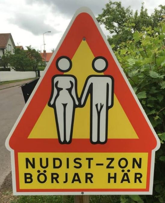 Varningsskylt med ikoner för en man och kvinna som markering för början på nudist-zon.