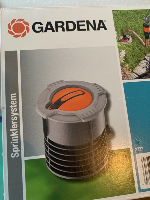 GARDENA sprinklersystem förpackning med bild av nedgrävd sprinklerkoppling i trädgård.