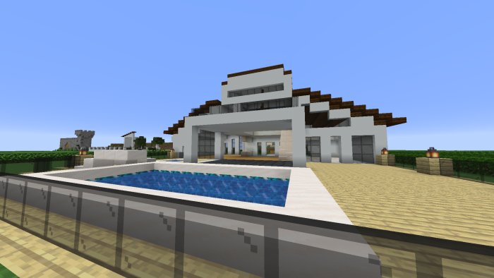 Minecraft-värld med en modern villa som har en pool, terrasser och detaljerade strukturer.