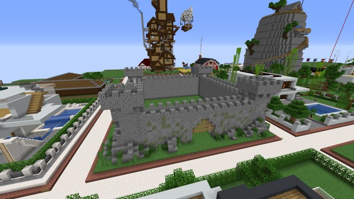 Minecraft-skapat landskap med stenfort och byggnader av olika stilar i bakgrunden.