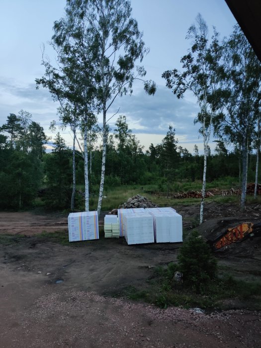 Isolering levererad till byggarbetsplats i skymningen, redo för nästa fas i byggprojektet.