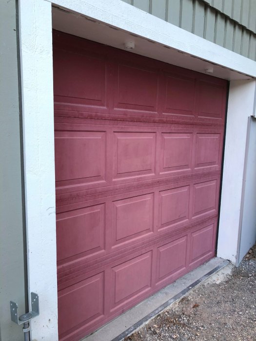 Röd garageport med nisch ovan där två spotlights med G4-sockel är monterade.