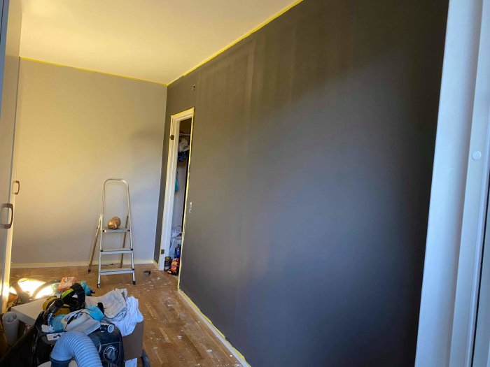 Renoverat kök med nymålade väggar och snobbrand, stege och byggmaterial syns.