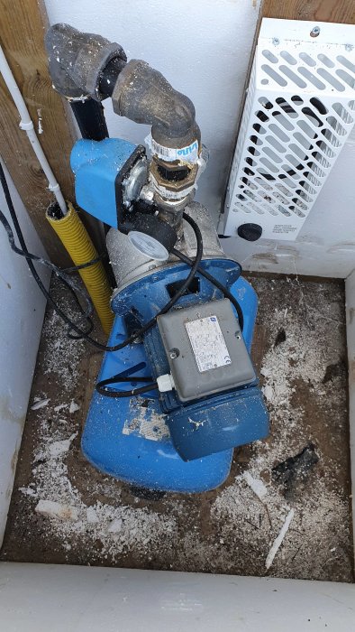 Bild på en Foras JXF 106 vattenpump ansluten till ett blått tryckkärl, placerade i ett pumphus.