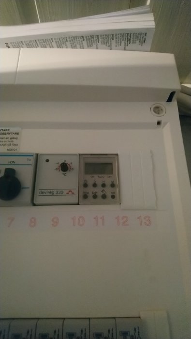 Timer i säkringsskåp med inställningsratt och digital display för utomhusbelysning.