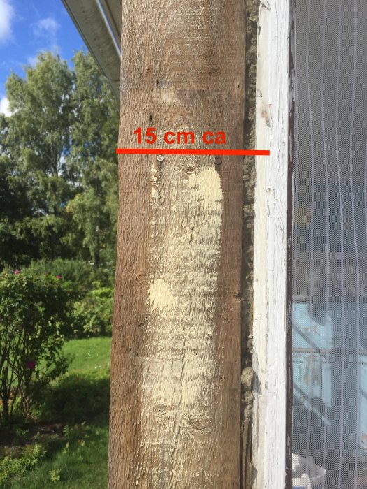 Träknut och dörrkarm på veranda med 15 cm mellanrum markerat för byggprojekt.