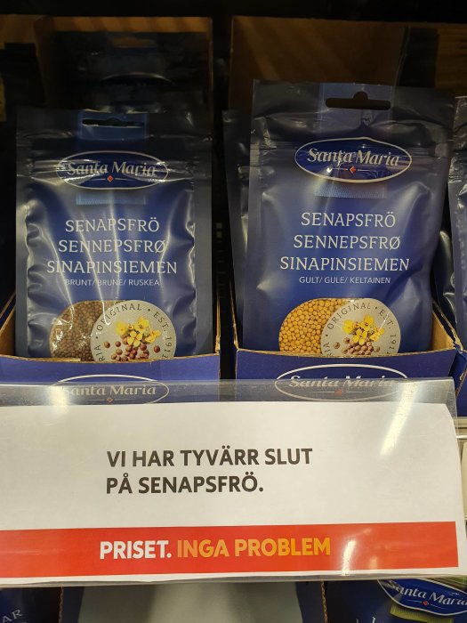 Två förpackningar senapsfrön i en hylla med en skylt som anger att produkten är slut.