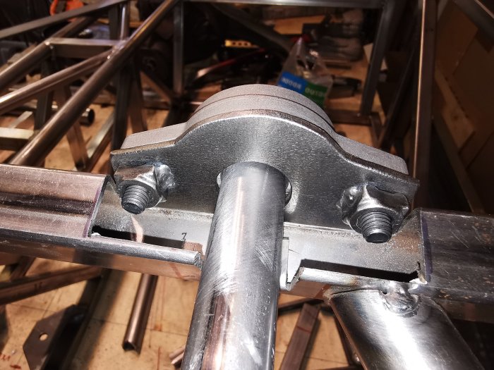 Montering av rattstångsfäste i metallram för ett byggprojekt.