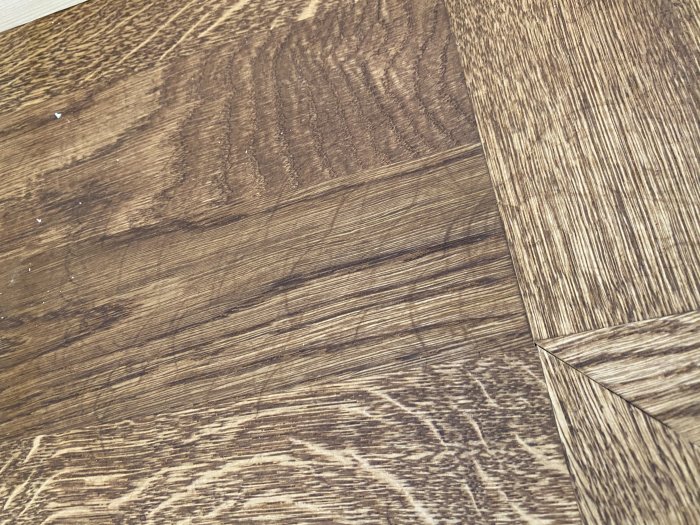 Nylagd fiskbensparkett i ek med synliga bearbetningsmärken och en borstad yta.