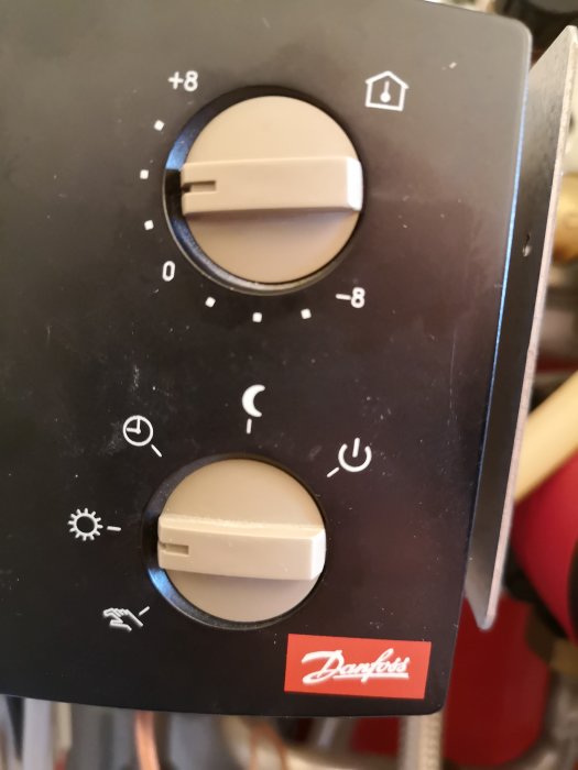 Reglagepanel på en Danfoss värmekontroll med termostatknappar.