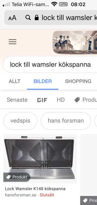 Svart lock till Wamsler kökspanna öppnat framför vit bakgrund.