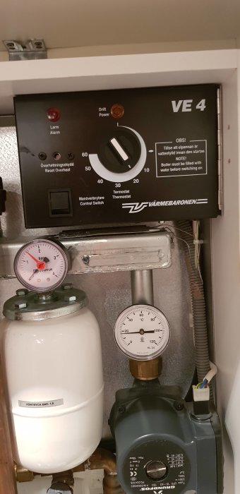 Värmesystem med kontrollpanel och mätare för temperatur och tryck.