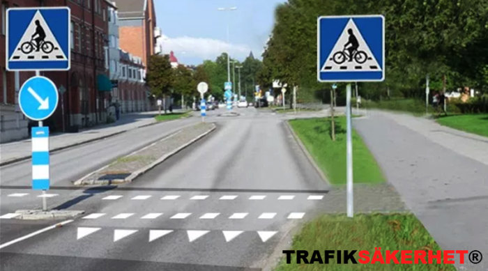 Vägkorsning med cykelöverfart och vägmarkeringar, skyltar som anger cykelväg och pil för riktning.