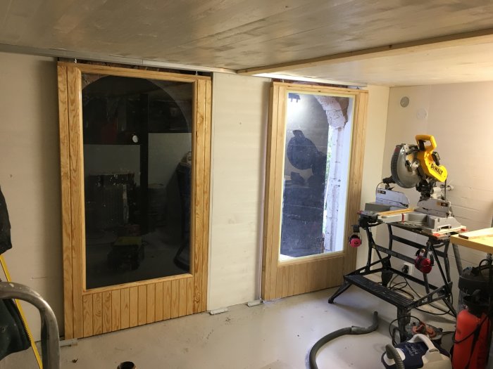 Inredd verkstad under en betongaltan med nya fönster och verktygsbord inklusive en gersåg.
