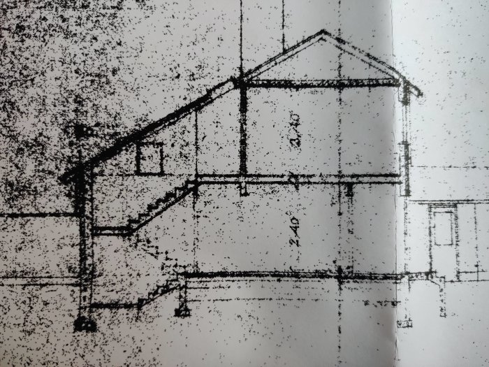 Suddig svartvit bild av en byggnadsritning med markerade bärverk och en detaljerad trappa.