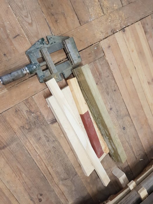 Eget tillverkat ställbart mothåll av plywood, fastklämt i maskinskruvstycke, på ett trägolv.