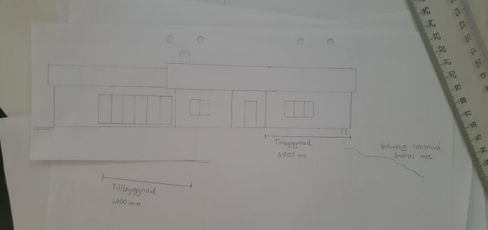 Handritad bygglovsritning av en husfasad med måttangivelser och tillbyggnadsdel.