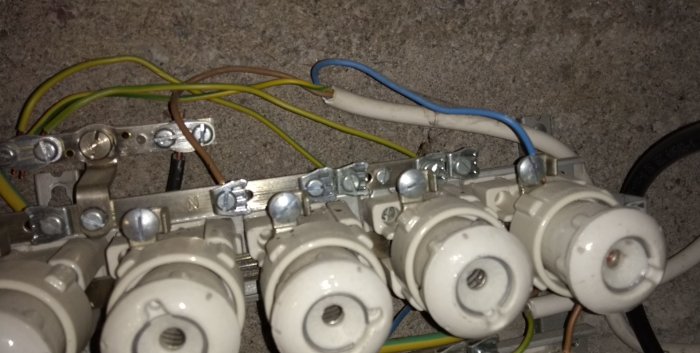 Elcentral med inkopplade kablar där en brun och en blå kabel är inkopplade felaktigt på noll- respektive fasskenor.