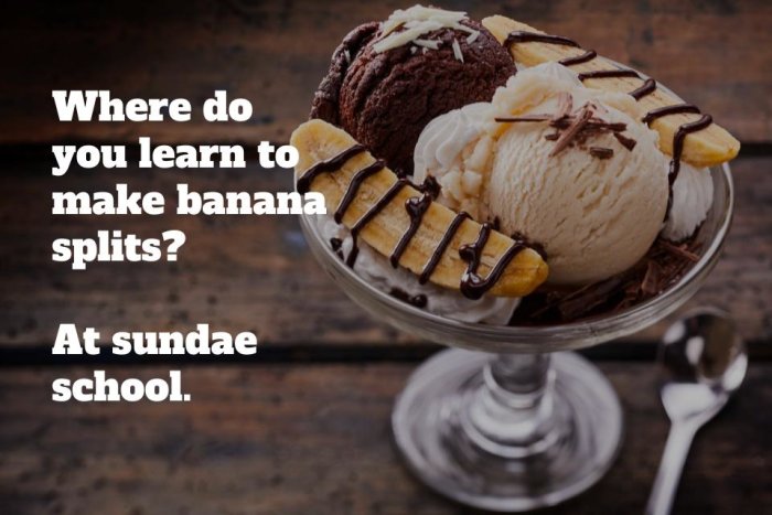 Bananasplit med glass, grädde, chokladsås och skämttext på träbakgrund.