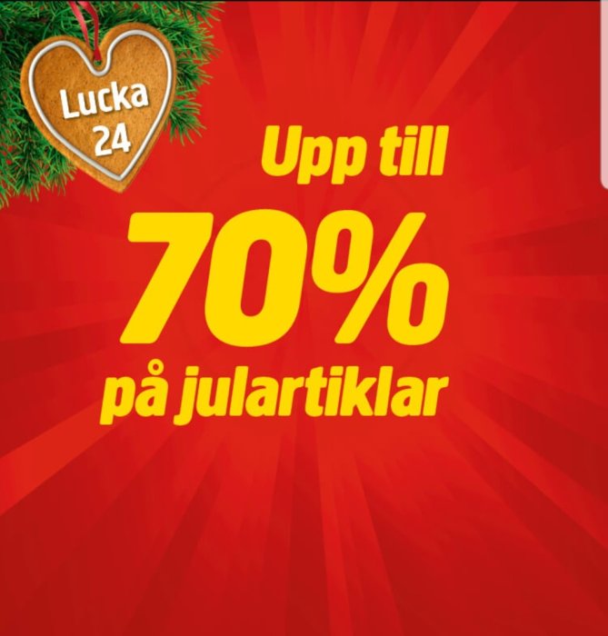 Reklambild för Julas julkampanj med texten "Upp till 70% på julartiklar" och "Lucka 24" på en pepparkaka.