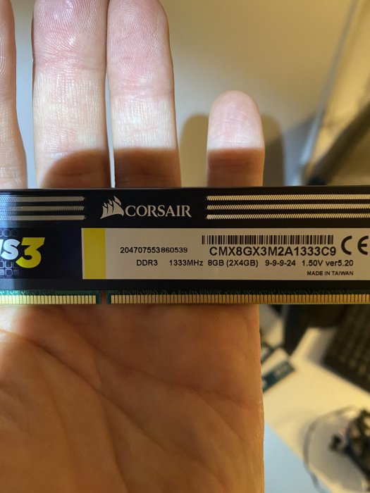 Hand håller upp Corsair DDR3 RAM-minne för datorer med specifikationer synliga.