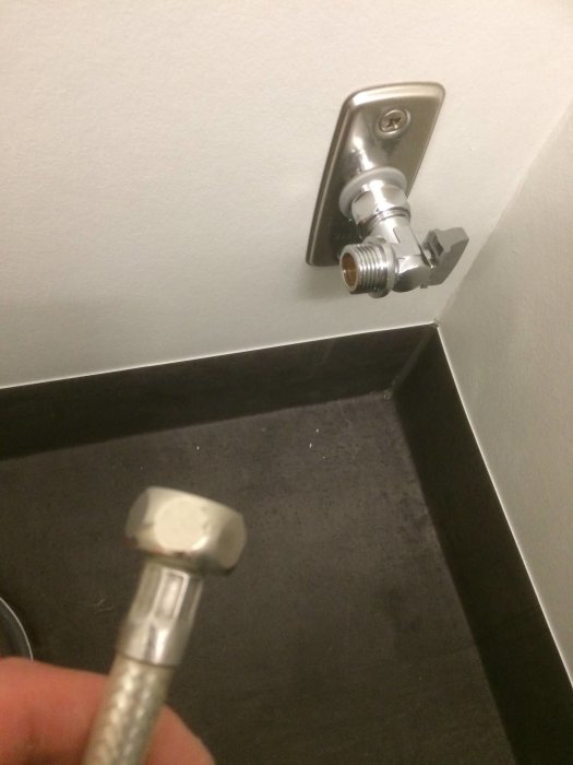 Installation av VA krom kulventil vinkel i badrum med synlig 3/8 mutter med packning och röranslutning.