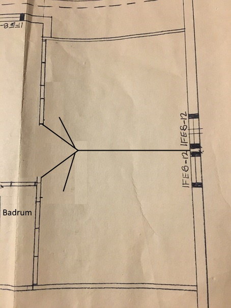 En arkitektonisk ritning med markerade eldragningar för två rum och en planerad vägg nära ett badrum.