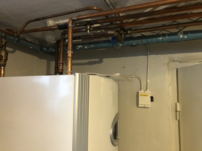 Källarrum med pannan och rörledningar, eventuell påfyllningsplats för värmesystemet.