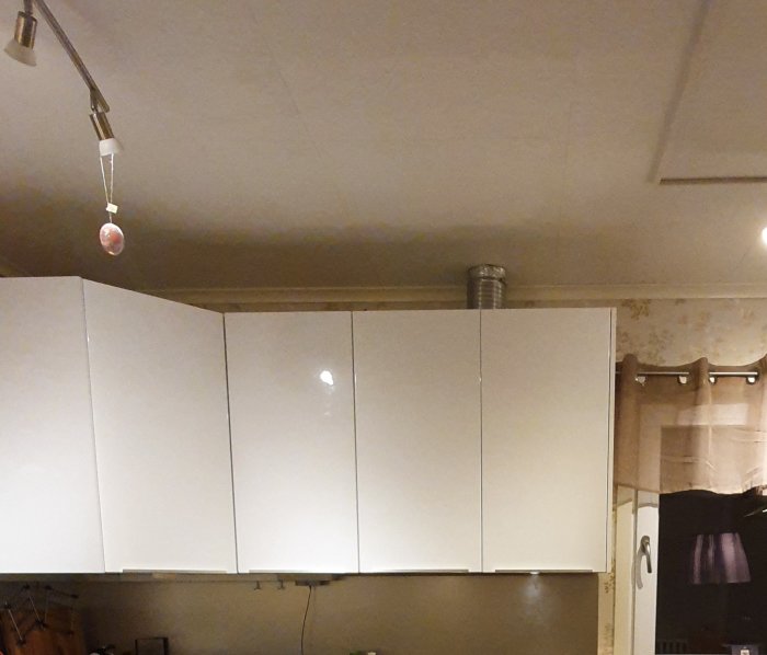 Köksskåp med ventilationsrör som sticker ut genom taket, resultaten av en DIY-renovering.