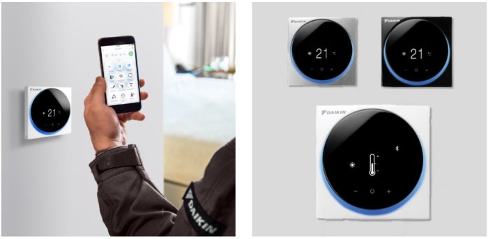 En person håller en smartphone med en kontrollapp framför en modern Daikin termostat på en vägg.