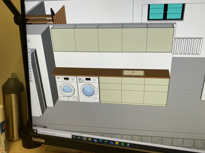 Skiss av tvättstuga med tvättmaskin och torktumlare på datorskärm, design i planeringsfas.