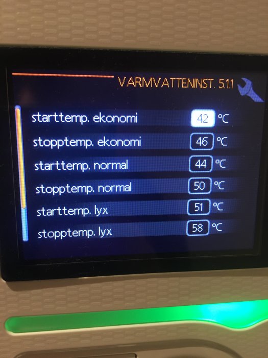 Digital display för varmvatteninställningar med temperaturvärden för ekonomi, normal och lyx.