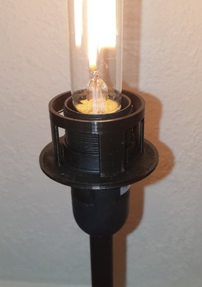 3D-utskriven adapter som förbinder en ljuskälla med en fjäderliknande lampskärm.