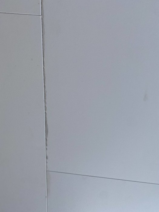 Grå fläckar längs takskarvar på en ljus takyta utan synliga tecken på fukt eller droppar.