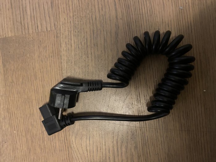 Spiralkabel med hane och hona ändar på trägolv som projekt för elintresserade.