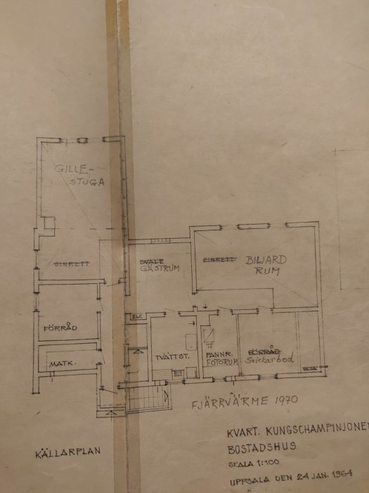 Gammal arkitektritning från 1964 av en huskällarplan med namngivna rum och måttangivelser, markerat för fjärrvärmeinstallation.
