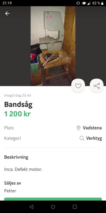 En begagnad Inca-bandsåg i ett garage med synliga reservdelar i en kartong framför, noterat att ha en defekt motor.