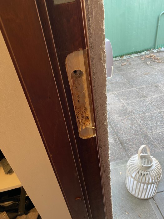 En dörr med omärkt urtagning och synlig äldre urtagning för lås till höger.