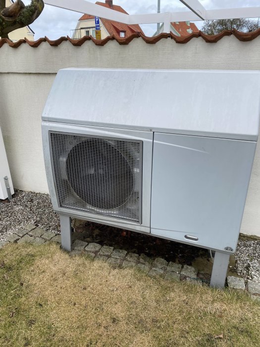 Utedelen av en CTC Ecoair värmepump från 2009 placerad utomhus med synlig isbildning.