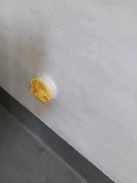 Detaljbild av badrumsmatta kring dosa med synlig skarv och tejprest, möjliga tätningssvårigheter nämnda.