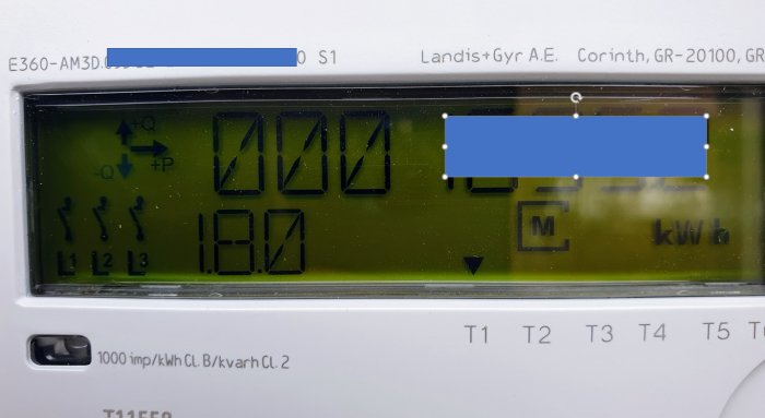 Elmätardisplay som visar siffror och symboler, inklusive en pil vid T1.