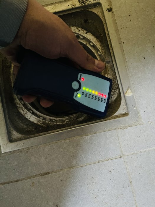 Fuktmätare visar höga fuktnivåer på golvet i ett renoverat hus.