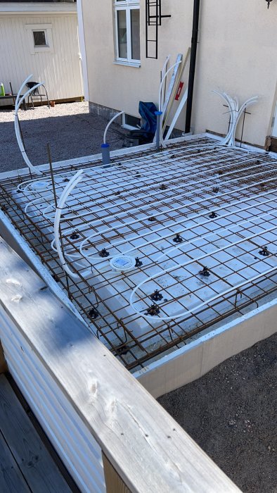 Installation av golvvärme med slingor och vattenrör på armeringsnät utomhus.